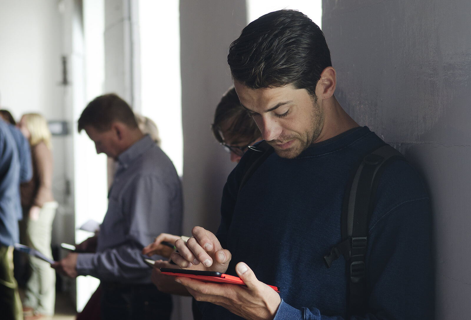People bent over phones, switching apps